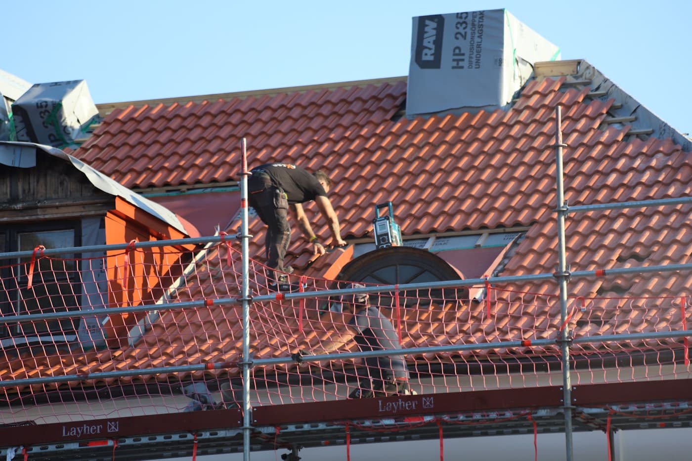 Roofing contractors working on a residential roof